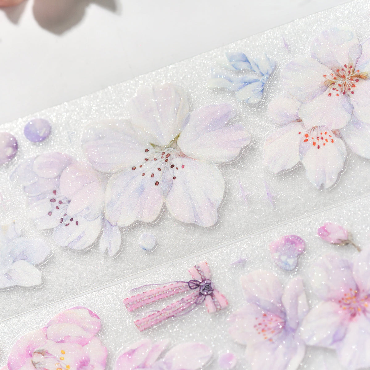 Cherry Blossom Glitter Sand PET die-cut tape die-cut edges with layered sakura silhouette and sparkling grain on white background