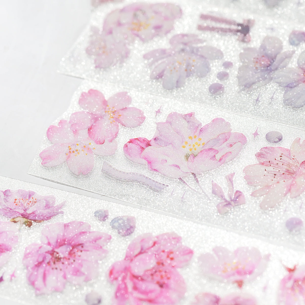 Cherry Blossom Glitter Sand PET die-cut tape arranged with scattered sakura motifs and glitter texture detail on white surface