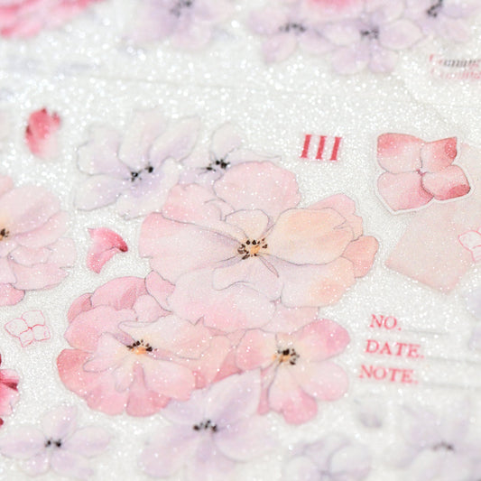Macro close-up of Crimson Blooms Glitter Sand PET die-cut tape with textured glitter grain and sparkling detail on white background