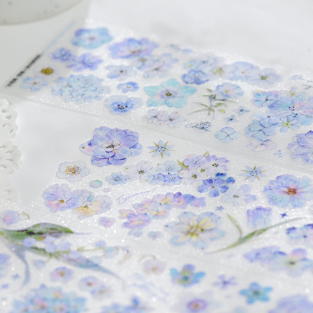 Kaleidoscope Shimmering Blue Glitter Sand PET die-cut tape full set of all designs in blue floral tones on white background