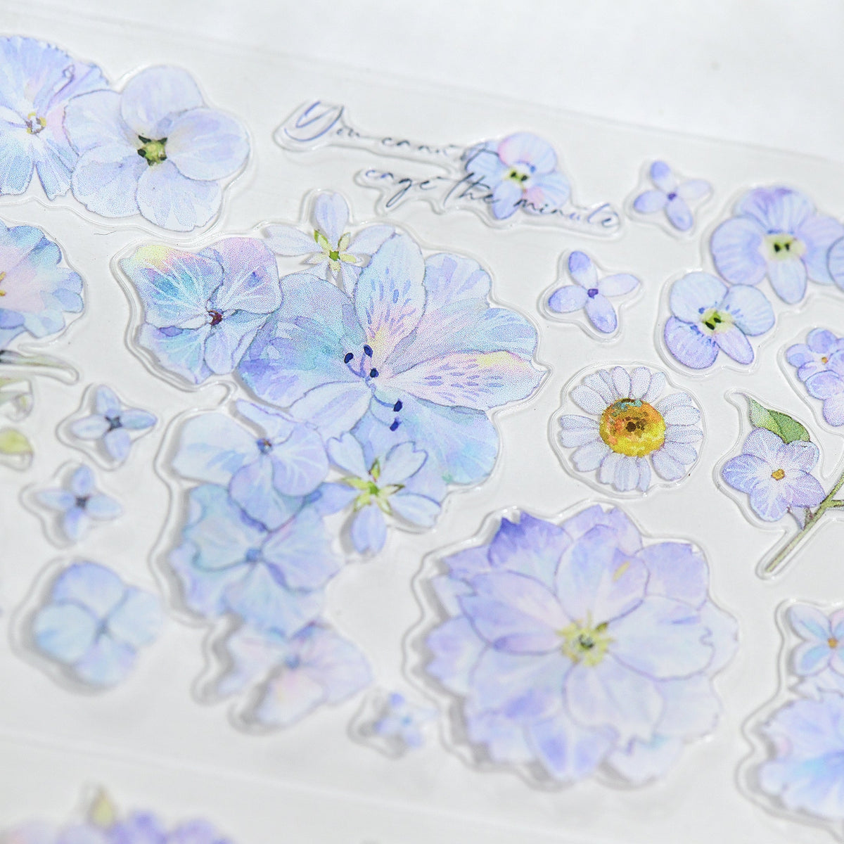 Macro close-up of Kaleidoscope Shimmering Blue Glitter Sand PET die-cut tape with textured glitter grain and layered blue blossom petals