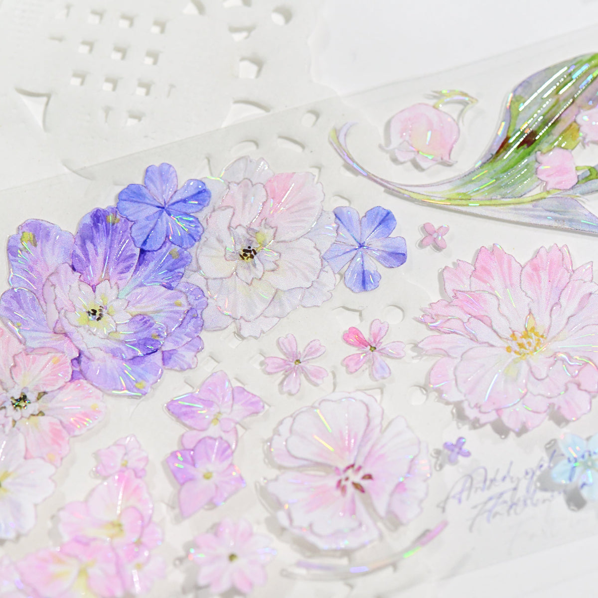 Close-up of Kaleidoscope Shimmering Pink Glitter Sand PET tape die-cut edges with glitter texture and pink flower silhouette on white background