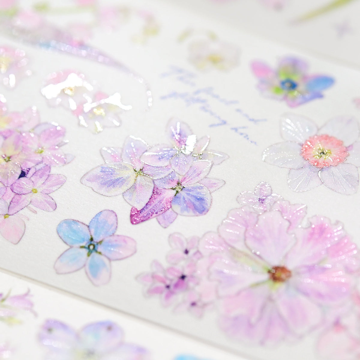 Macro close-up of Kaleidoscope Shimmering Pink Glitter Sand PET die-cut tape with textured glitter grain and layered pink blossom petals