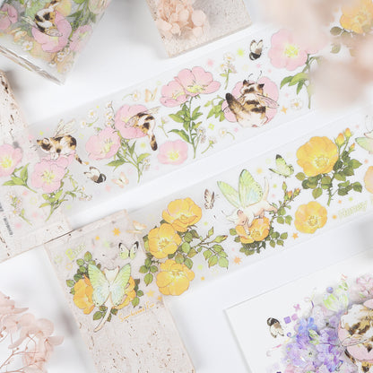 Handheld macro of Watercolor Cute Kittens Sweet Orchard Wildflower Fairy PET tape with warm neutral beige watercolor kitten design and orchard botanical accents, sparkling glitter texture and journal elements styled in the background

