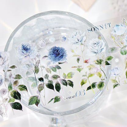Wilderness Rose Glacial Blue Glossy PET die-cut tape full roll display with smooth glossy sheen and blue rose motifs on white background
